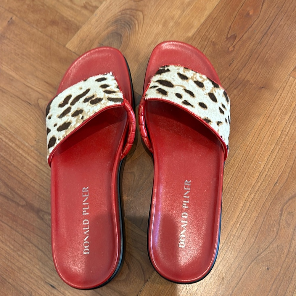 Donald Pliner slides with animal print.
